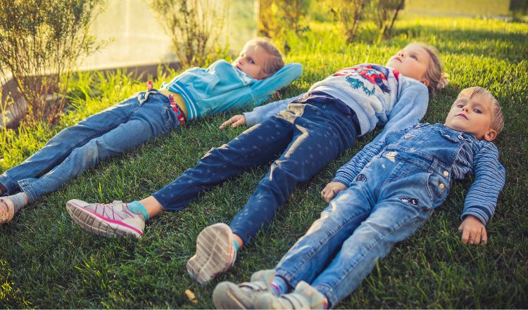 3 kids relaxing on the lawn - ahhhh - vacation